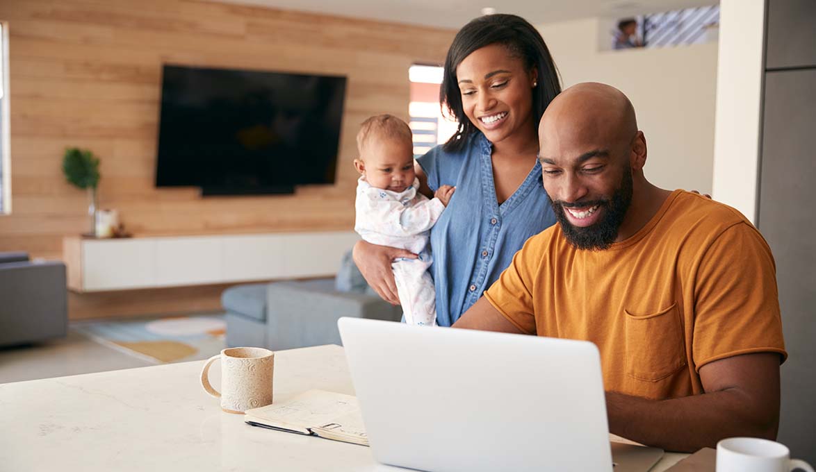 young family learning SouthState Account online banking on laptop