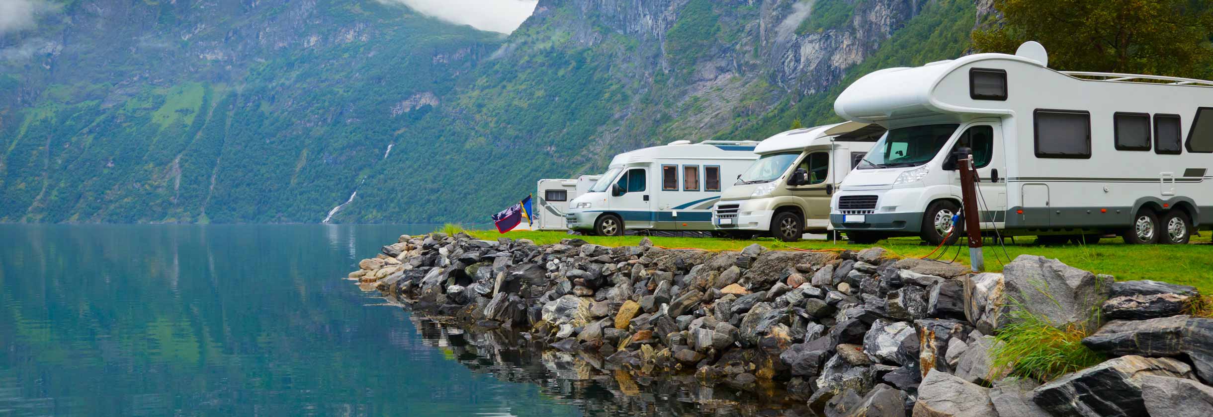 Group of Motorhomes parked by a lake