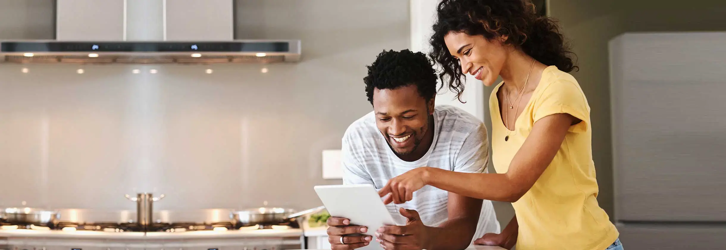 Couple using tablet in the kitchen