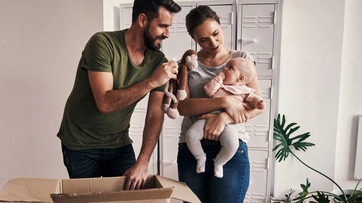 image for family with baby unboxing items in new home