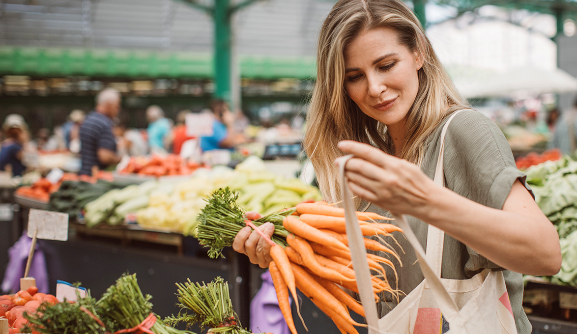 Customer holding carrots at farmers market