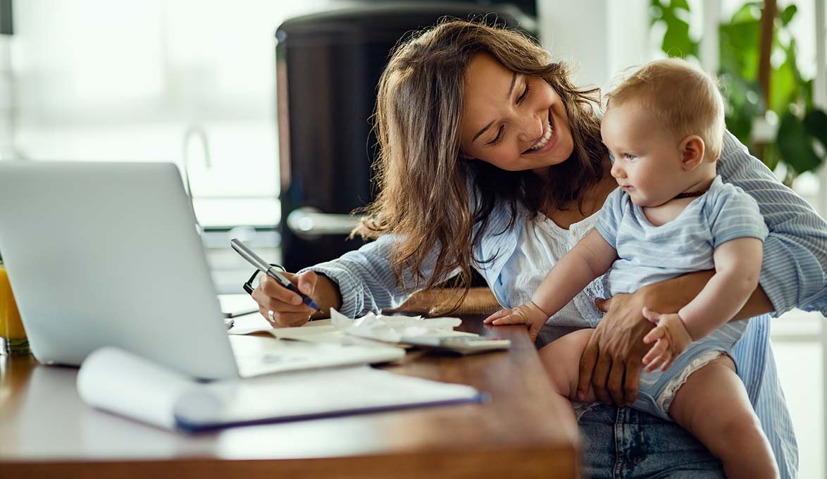 young mom making smart financial goals with baby child