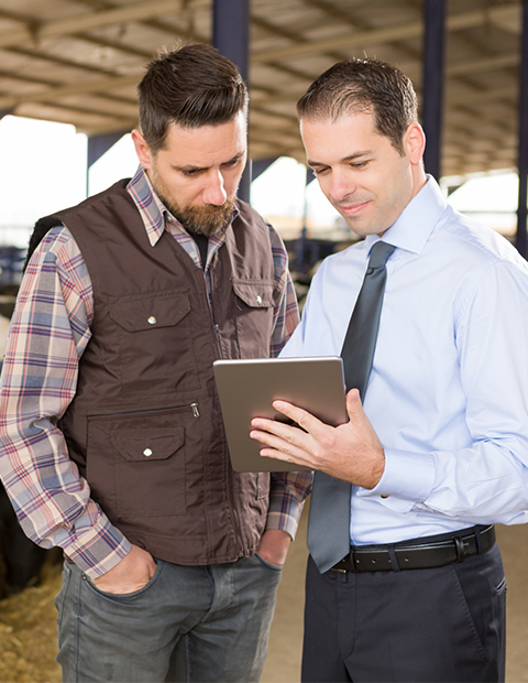 promo image for Farmer reviewing USDA loan process with small business banker