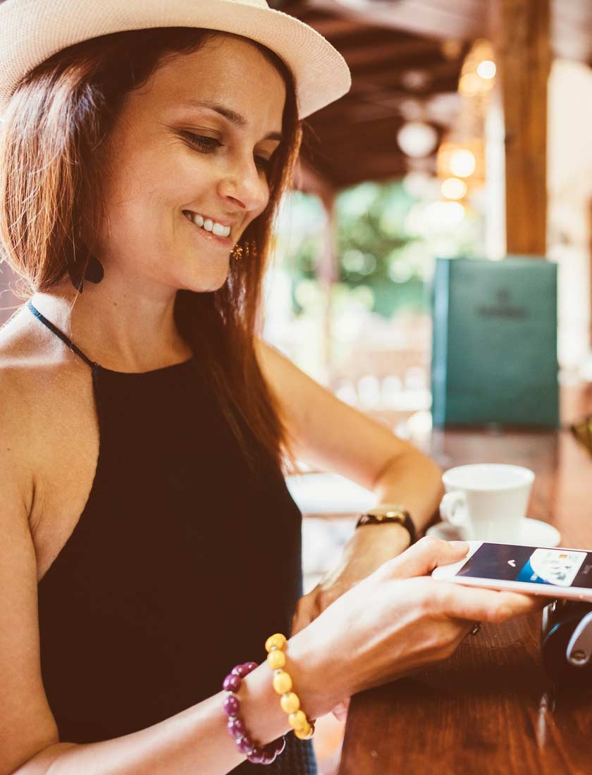 woman using contactless digital wallet at a cafe